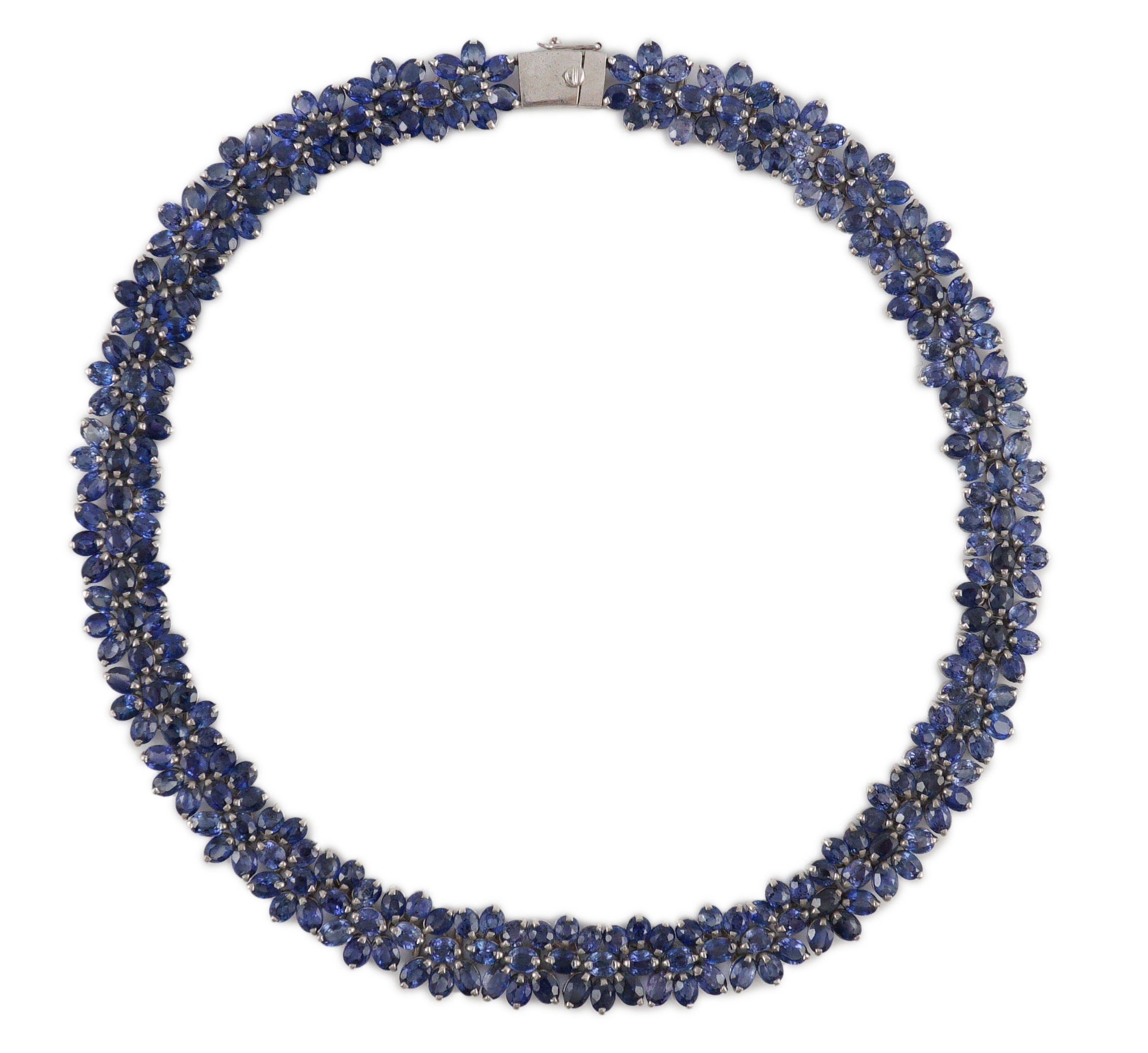 An 18K white gold and synthetic sapphire? flower head cluster set necklace